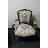 An antique style carved walnut armchair in tapestry fabric