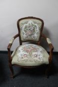 An antique style carved walnut armchair in tapestry fabric