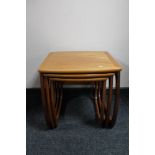 A nest of three teak tables