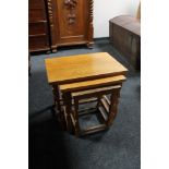 A nest of three light oak tables