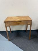 An oak side table fitted with a drawer