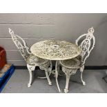 An antique style painted metal patio table and two chairs