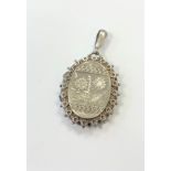 An ornate antique silver locket CONDITION REPORT: In good condition. Clasp working.