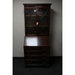 A reproduction mahogany bureau bookcase