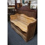 A pine shaped fronted box settle