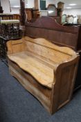 A pine shaped fronted box settle