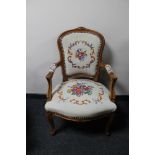 An antique style carved walnut armchair in tapestry fabric