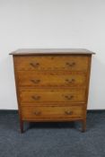 An Edwardian inlaid mahogany four drawer chest