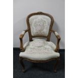 An antique style carved walnut armchair in tapestry fabric
