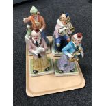 Four musical pottery clown figures
