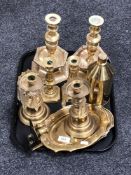 A tray of brass wall candle sconces, two pairs of brass candlesticks,