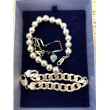 A silver bead bracelet, an enamelled bracelet and a silver curb link bracelet.