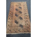 An Afghan Bokhara rug on brown ground,