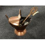 A Victorian copper swing handled coal scuttle with shovel, carpet beater,