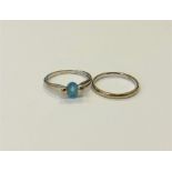 A 9ct gold blue topaz ring and a 9ct gold band ring. (2) CONDITION REPORT: 4.