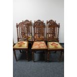 A set of seven carved oak dining chairs