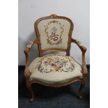 An antique style carved walnut armchair in tapestry fabric