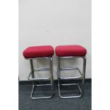 A pair of tubular metal bar stools