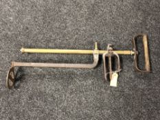 An antique brass and cast iron garden sprayer