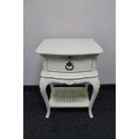 A cream painted single drawer bedside table