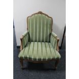 A carved walnut framed striped armchair