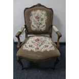 A carved walnut armchair with tapestry covering