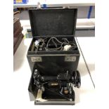 A vintage electric singer sewing machine in box together with accessories, pedal.