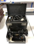 A vintage electric singer sewing machine in box together with accessories, pedal.