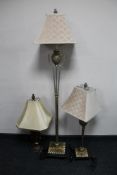 A silvered contemporary standard lamp together with two similar table lamps