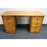 A pine dressing table fitted eight drawers