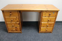 A pine dressing table fitted eight drawers