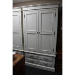 A contemporary white double door wardrobe fitted with four drawers