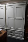 A contemporary white double door wardrobe fitted with four drawers