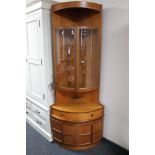 A teak corner cabinet