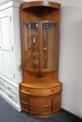 A teak corner cabinet