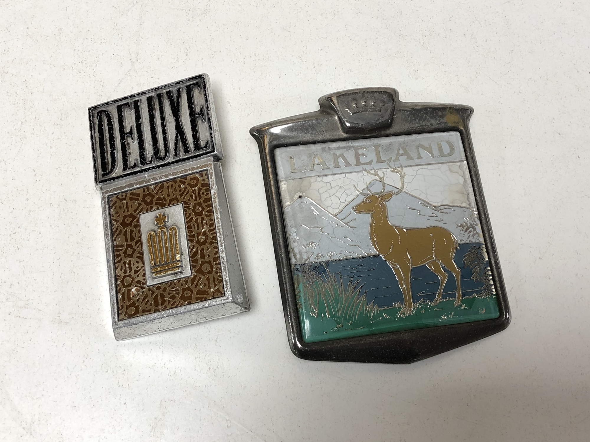 Two vintage car badges - Lakeland and Deluxe