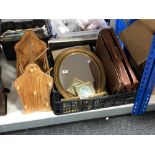 A box of oval gilt mirror, picture frames, leather satchel,