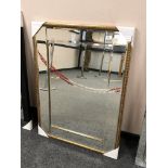 A gold-tone all glass mirror