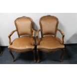 A pair of carved walnut armchairs