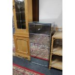 A mirrored bedside cabinet