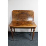 A nineteenth century walnut tea table CONDITION REPORT: Split to veneer on top.