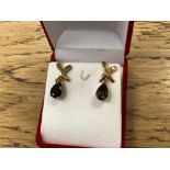A pair of pair shaped quartz earrings in yellow gold