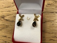 A pair of pair shaped quartz earrings in yellow gold