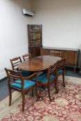 A reproduction mahogany twin pedestal dining table and six chairs