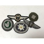 Five pieces of military cloth insignia