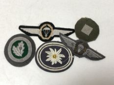 Five pieces of military cloth insignia