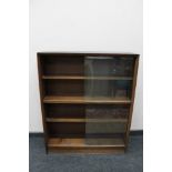 A teak sliding door bookcase