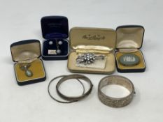 Three silver bangles, paste brooch, silver Wedgwood pendants,