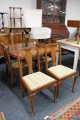 A walnut pull out dining room table and four chairs