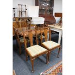 A walnut pull out dining room table and four chairs